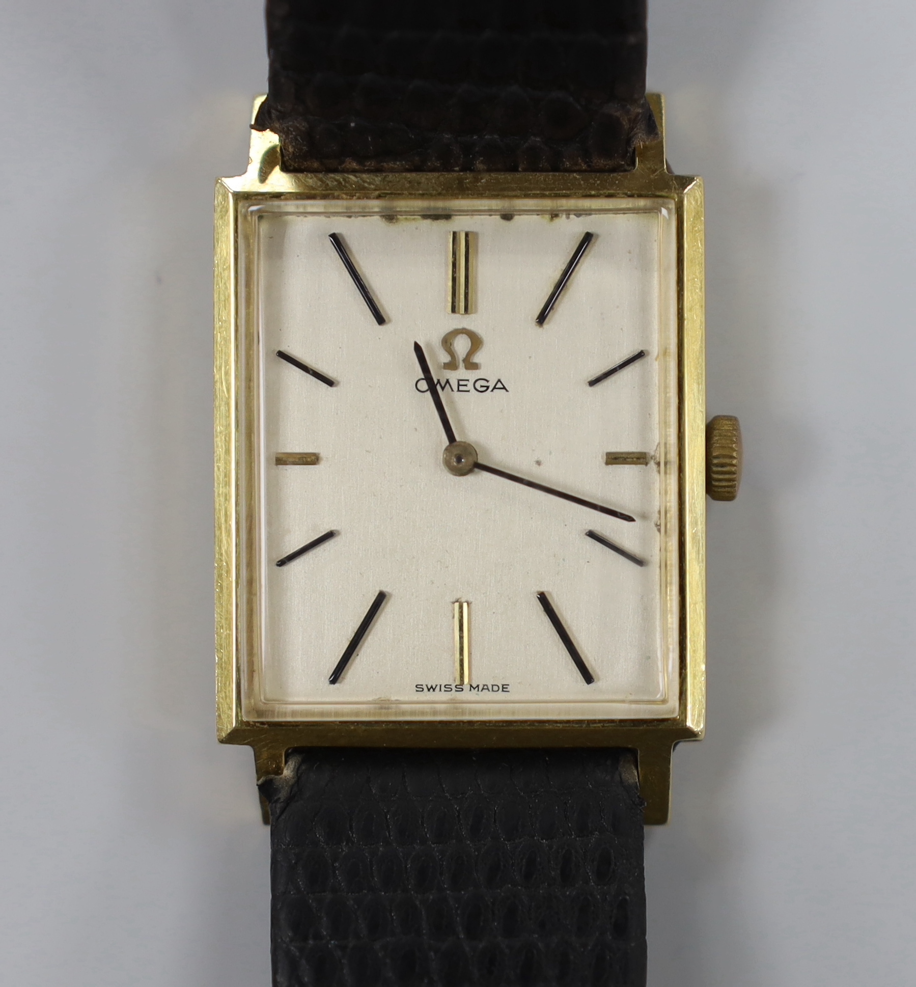 A gentleman's 18k Omega manual wind rectangular dress wrist watch, on associated leather strap, case diameter 24mm, no box or papers.